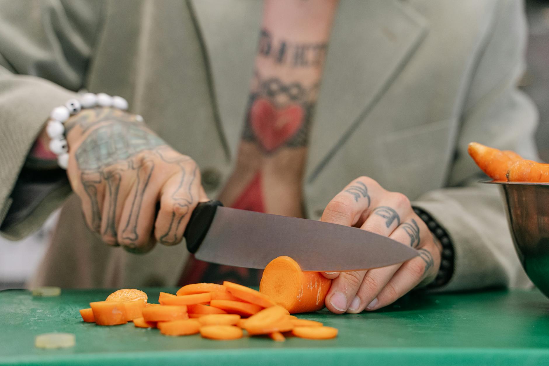 a person cutting carrots